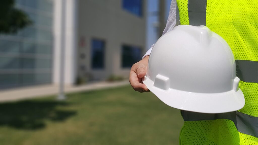 Person holding hardhat.